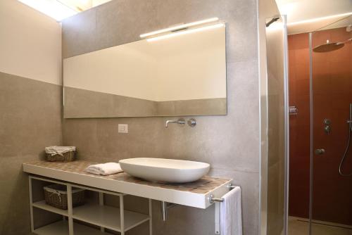 a bathroom with a sink and a mirror at Li Frati Suite in Lecce