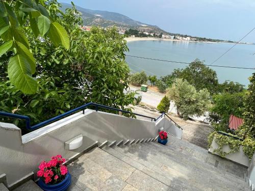 a balcony with a view of a beach and the ocean at La Casa di Anastasia - Panorama Nea Karvali in Néa Karváli