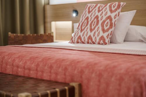 a bed with a red comforter and pillows at Can Guixe - Turismo de Interior in Inca