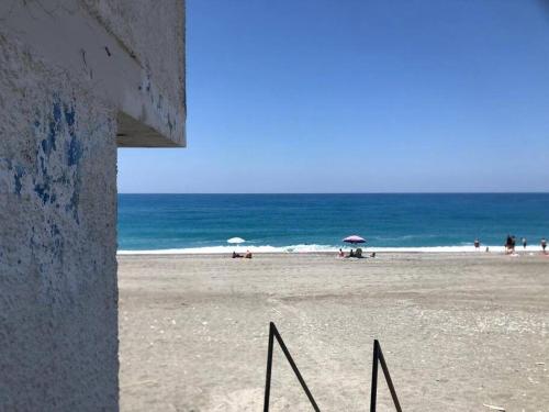 a view of a beach with people and the ocean at Stella d'Aurora waterview in Belmonte Calabro