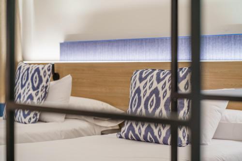 a bedroom with two bunk beds with blue and white pillows at Can Guixe - Turismo de Interior in Inca