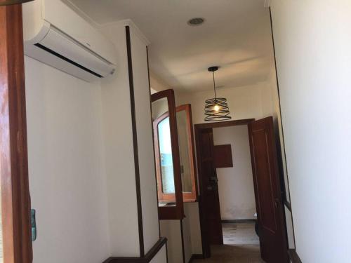 a hallway with a door and a window and a light at Stella d'Aurora waterview in Belmonte Calabro