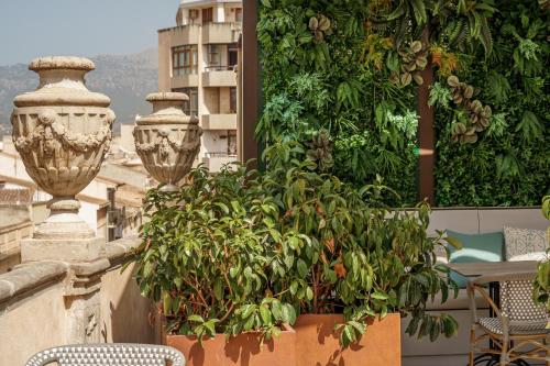 a balcony with chairs and plants on a building at Can Guixe - Turismo de Interior in Inca