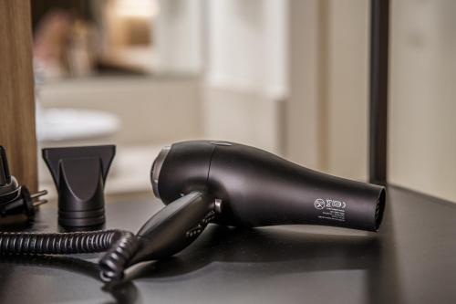 a black hair dryer sitting on a table at Can Guixe - Turismo de Interior in Inca