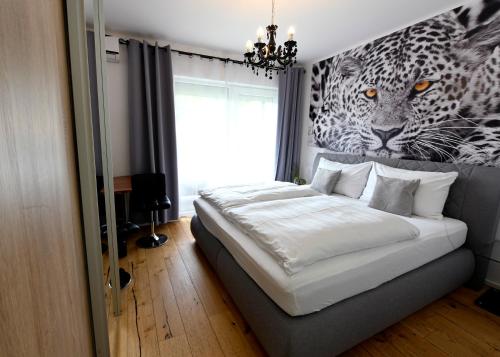 a bedroom with a bed with a mural of a leopard at Enjoyit Rooms in Velden am Wörthersee
