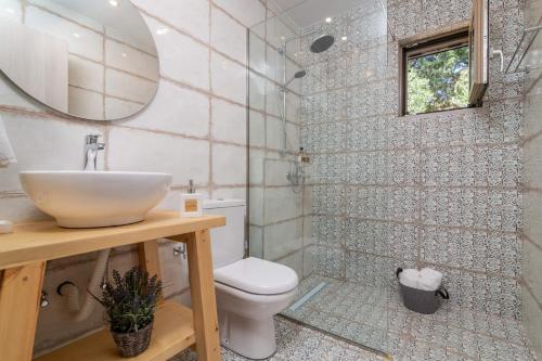 a bathroom with a sink and a toilet at Villa Ionio Deste by Villa Plus in Vasilikos