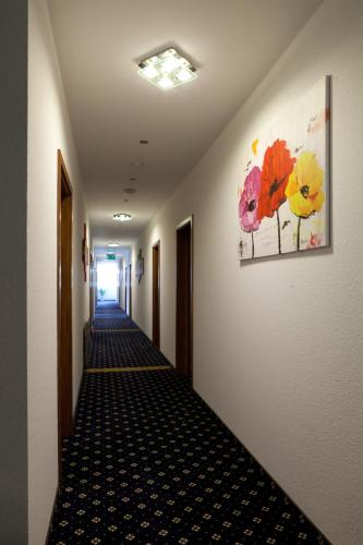 a hallway in a hospital with a painting on the wall at Hotel Deutscher Hof in Babenhausen