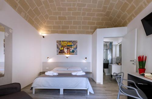 a bedroom with a bed and a living room at Nà Nonna Affittacamere in Favignana