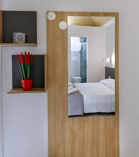 a bedroom with a mirror and a bed at Nà Nonna Affittacamere in Favignana
