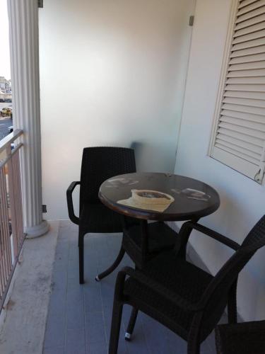 a table and two chairs on a balcony at Hotel Tiffany in Varcaturo