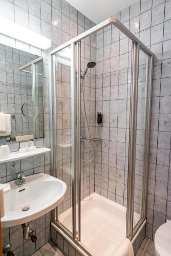 a bathroom with a shower and a sink at Cityhotel Trumer Stube in Salzburg