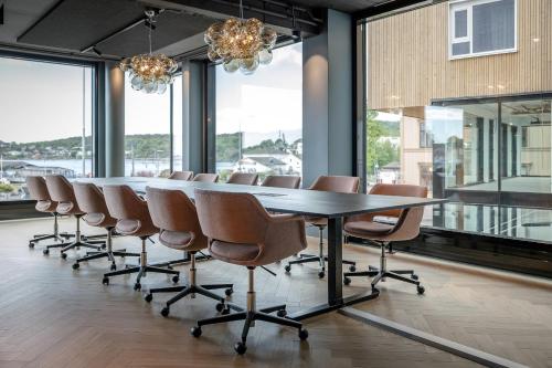 a conference room with a long table and chairs at Quality Hotel Grand Larvik in Larvik