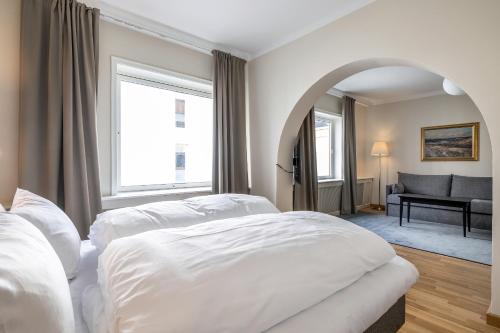 a hotel room with two beds and a window at Quality Hotel Grand Larvik in Larvik