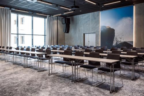 a room with rows of tables and chairs at Quality Hotel Grand Larvik in Larvik