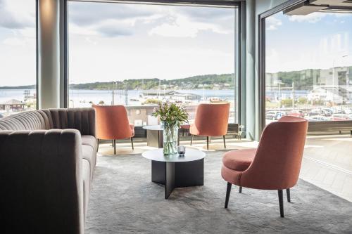 a living room with a couch and chairs and a table at Quality Hotel Grand Larvik in Larvik