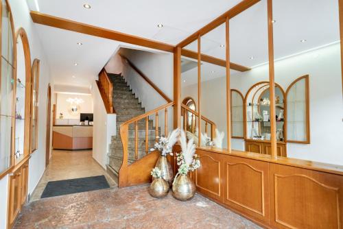 a hallway of a home with a staircase and a lobby at Cityhotel Trumer Stube in Salzburg