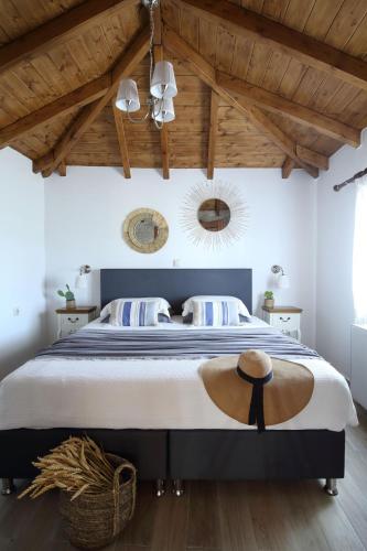 a bedroom with a large bed with a wooden ceiling at Panorama Villas in Drymon