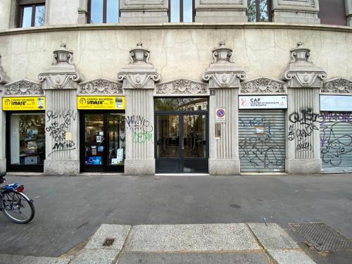 a building with graffiti on the front of it at Richard's Apartments - 22 Marzo in Milan