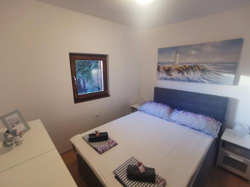 a bedroom with a bed with two pillows on it at LEA in Bakarac