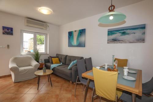 a living room with a couch and a table at Adria Apartment in Hvar