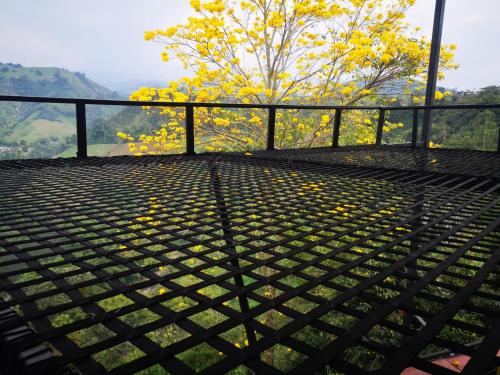 a black metal platform with a tree in the background at Finca Campestre Villa del Campo in Santa Rosa de Cabal