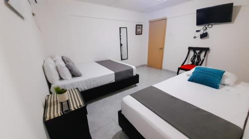 Postel nebo postele na pokoji v ubytování Hotel Poblado Suite