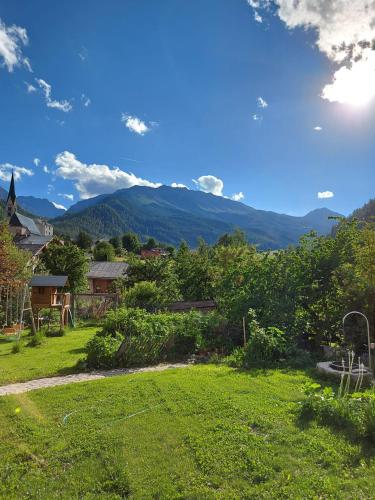 a view of a yard with mountains in the background at Hotel Crusch Alba Sta Maria in Sta Maria Val Müstair