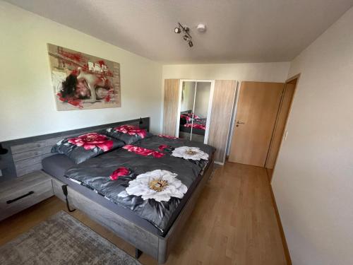 a bedroom with a bed with flowers on it at Ferienwohnung Dinkelberg in Steinen