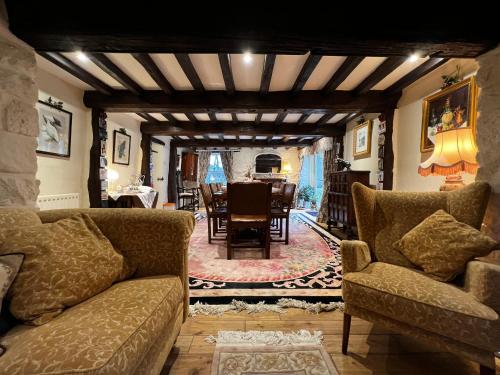 a living room with a couch and a dining room at Picket Post House Bed & Breakfast in Catterall