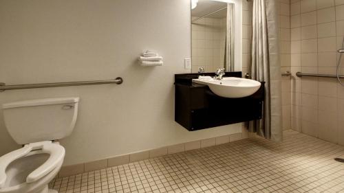 a bathroom with a sink and a toilet at Super 8 by Wyndham Woods Cross - Salt Lake City North in Woods Cross