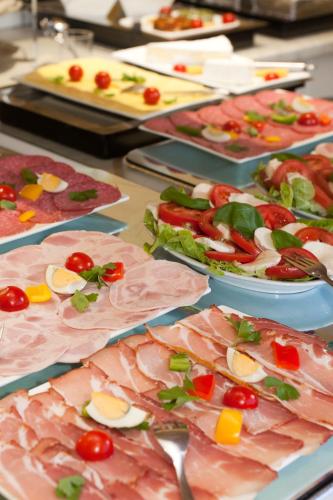 a buffet filled with different types of food on plates at Hotel Deutscher Hof in Babenhausen