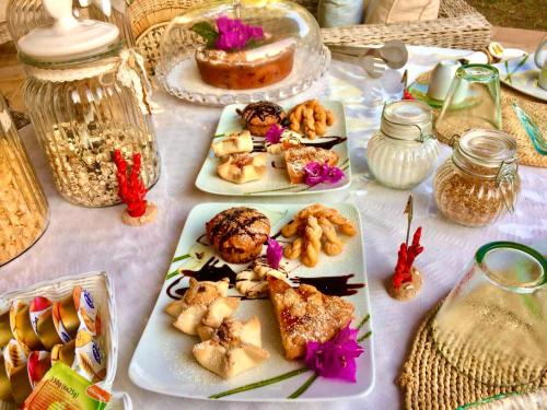 a table with three plates of food on it at Villa Franci in Santa Teresa Gallura