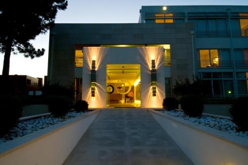 a building with a pathway leading to the front door at Lavanda Hotel Miravillas in Praia de Mira