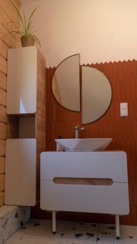 a bathroom with a sink and a mirror at Apartament Sasinowe Zacisze in Sasino