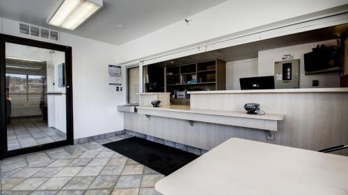 a fast food restaurant with a counter and a window at Super 8 by Wyndham Woods Cross - Salt Lake City North in Woods Cross