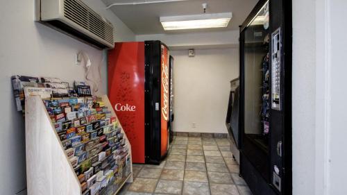 a room with a soda vending machine and a room at Super 8 by Wyndham Woods Cross - Salt Lake City North in Woods Cross