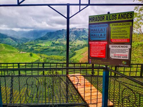 a sign for a bus stop with mountains in the background at Finca Campestre Villa del Campo in Santa Rosa de Cabal