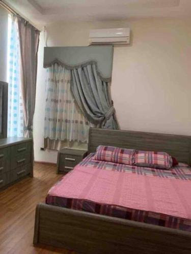 a bedroom with a bed with a pink blanket at North coast sedra resort villa قريه سيدرا الساحل الشمالي in Alexandria