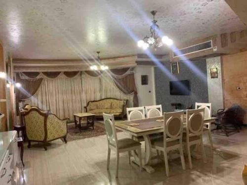 a living room with a table and chairs at North coast sedra resort villa قريه سيدرا الساحل الشمالي in Alexandria
