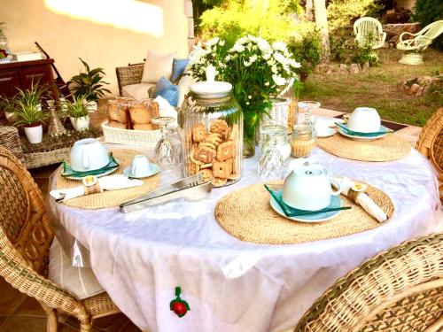 a table with a white table cloth with food on it at Villa Franci in Santa Teresa Gallura