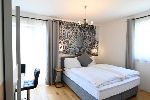 a bedroom with a bed with a mural of a tiger at Enjoyit Velden West in Selpritsch
