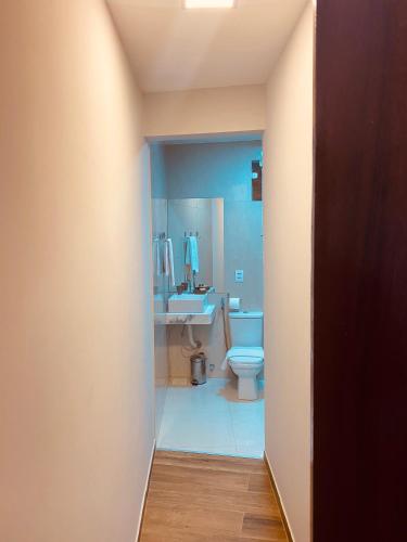 a bathroom with a white toilet and a sink at Beach Eco Stays Hotel Boutique Lagoinha in Tigre