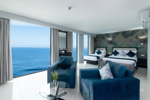 a hotel room with a bedroom and a bed and a couch at MaRadha Colombo in Colombo