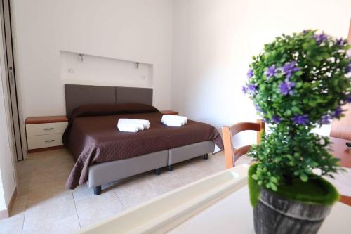 a bedroom with a bed and a plant on a table at Agriturismo Monte Istulargiu in Valledoria