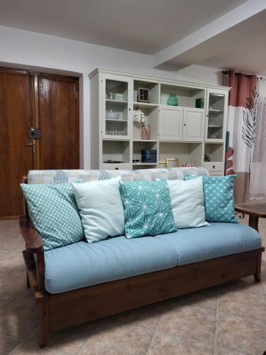 a couch with pillows on it in a room at Casa Twins in Sassari