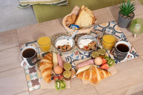 a table with eggs bread and toast and two cups of coffee at Minas Apartments in Divarata