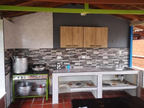 a kitchen with a counter top and a sink at Finca Campestre Villa del Campo in Santa Rosa de Cabal