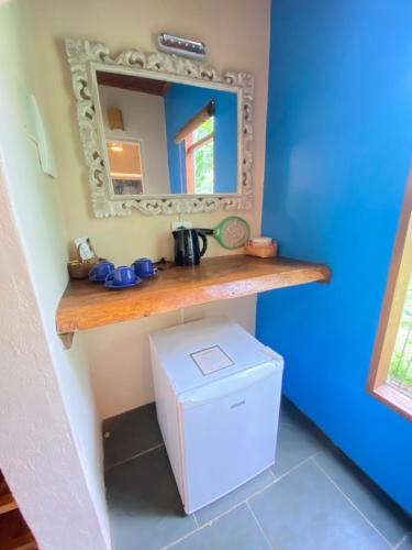 a bathroom with a sink and a mirror at Banana Bamboo Ecolodge in Ubatuba