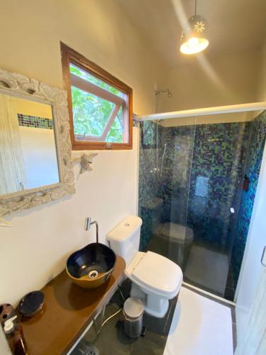 a bathroom with a sink and a toilet and a shower at Banana Bamboo Ecolodge in Ubatuba