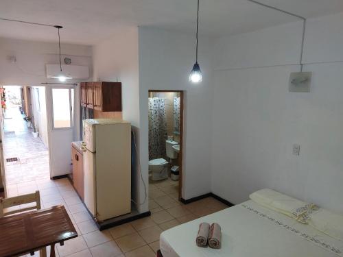 a kitchen with a refrigerator and a table and chairs at Ñandubay1 in Puerto Iguazú